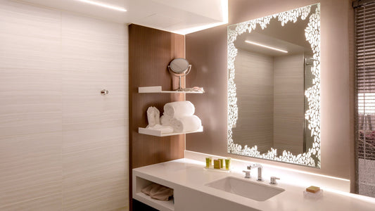 Beautiful etched forte lighted mirror in a serene hotel guest bathroom