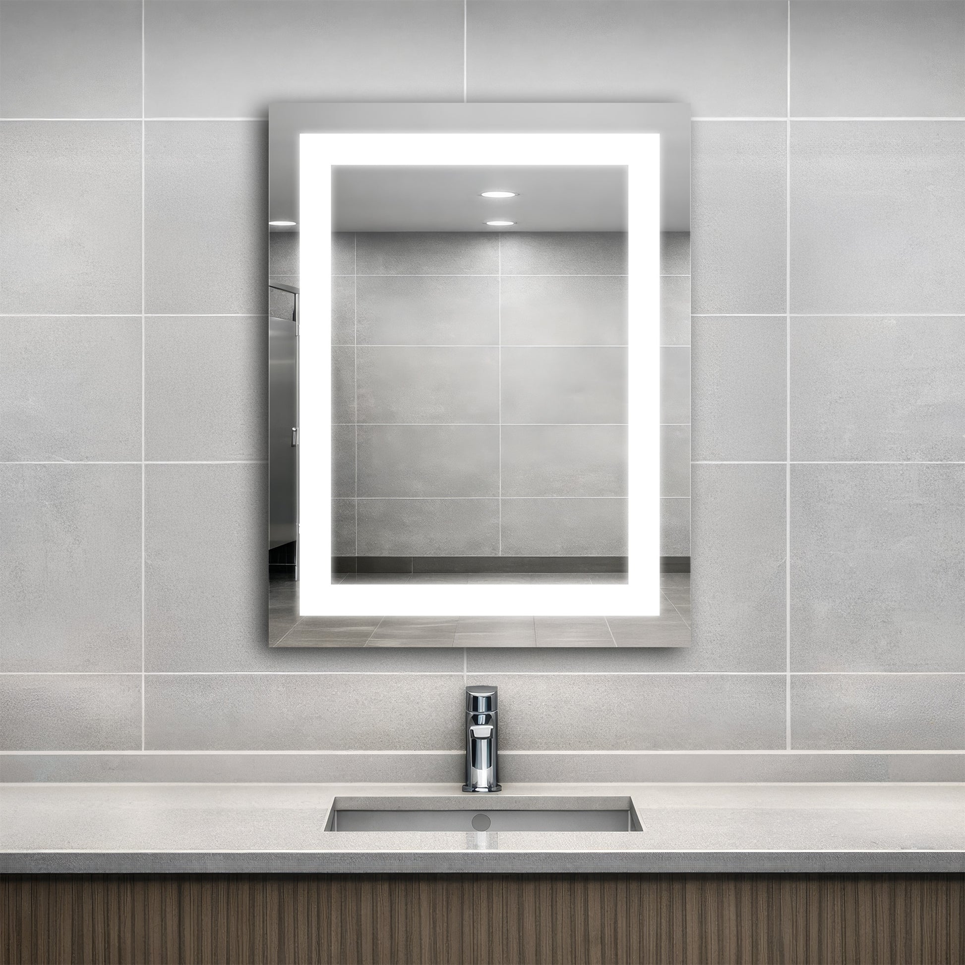 Bathroom with an Align lighted mirror above a sink against a tiled wall.