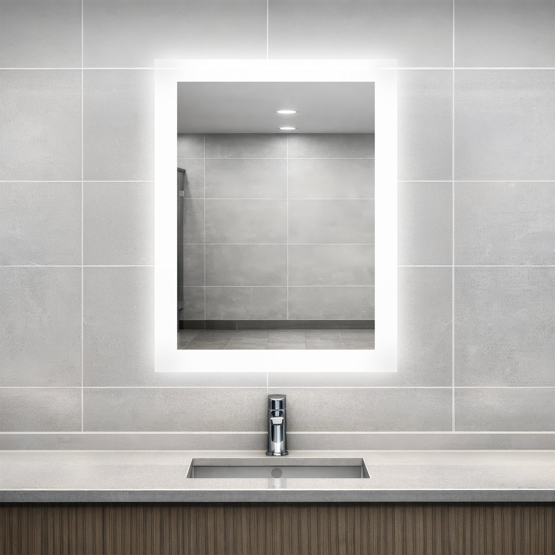 Bathroom vanity with Facet lighted mirror and sink.