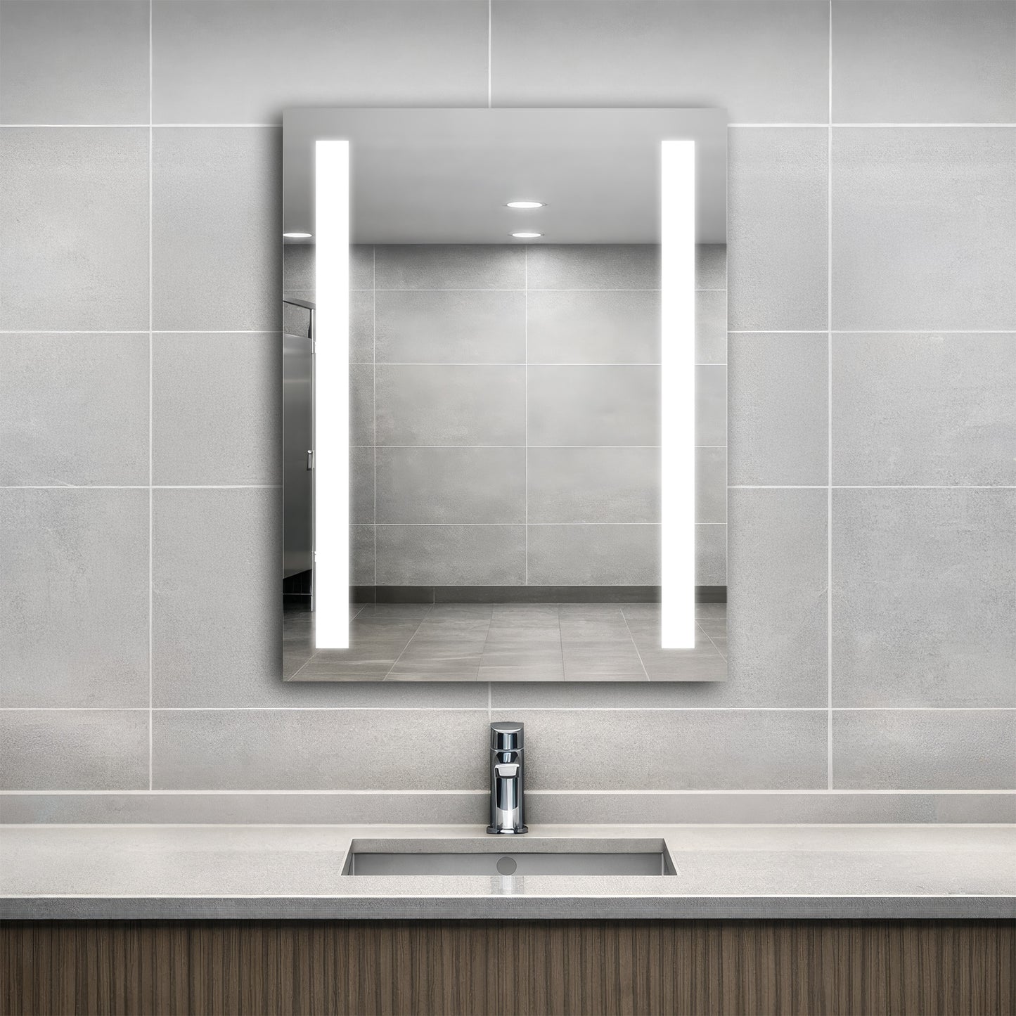 Bathroom with a modern sink and Ledge lighted mirror on a tiled wall.